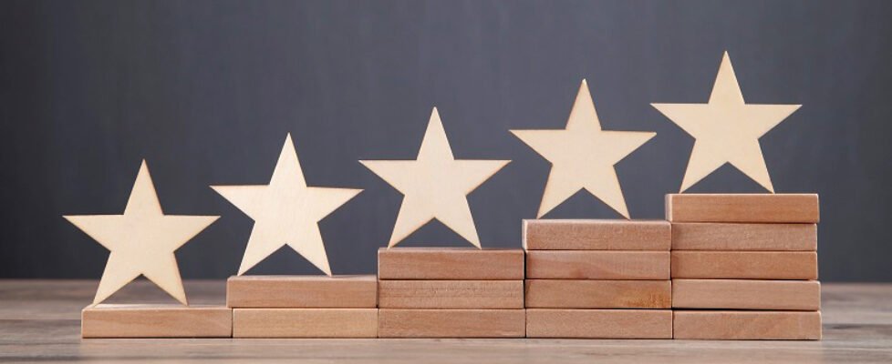 Wooden 5 stars on wooden block. Increase rating