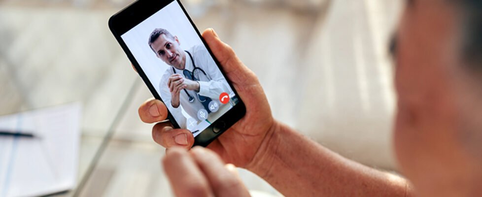 Happy old man meet his doctor via video call by smart phone at h