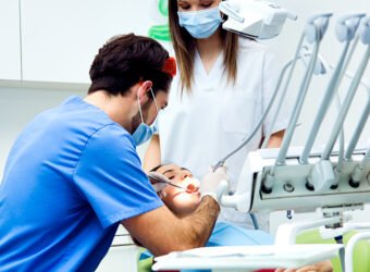 Cute young woman at the dentist. Mouth checkup