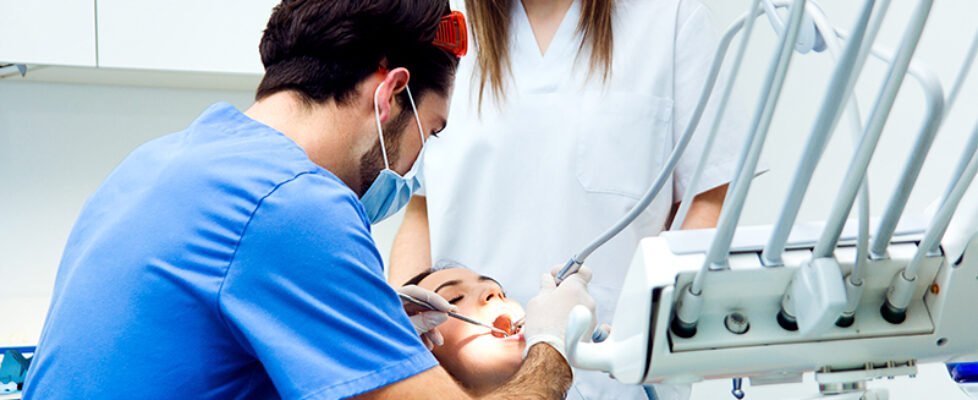 Cute young woman at the dentist. Mouth checkup