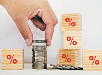 Interest rate financial and savings concept. Hand putting coins