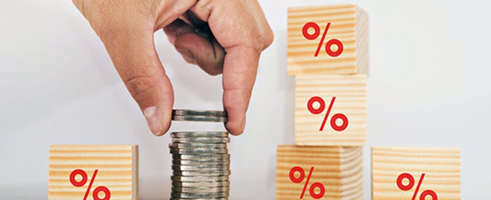 Interest rate financial and savings concept. Hand putting coins