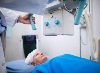 Senior woman undergoing an x-ray test in hospital