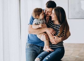Young family with their little son at home