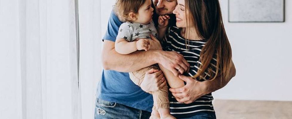 Young family with their little son at home