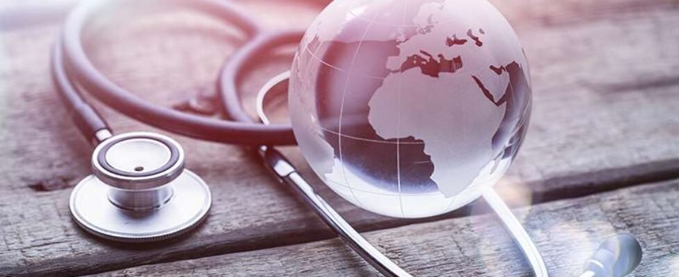 glasd global and stethoscope on wood table, healthcare concept,