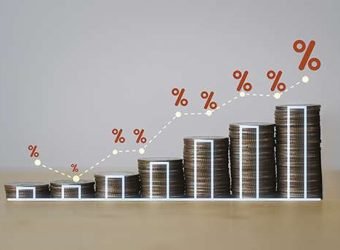 Increasing coin stacking with percentage sign and graph for hous