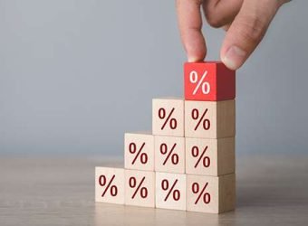 Hand arranging wood block stacking with icon percent symbol upwa