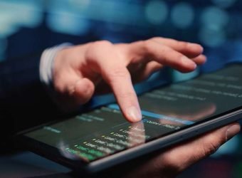 Male system administrator inspecting big data on tablet