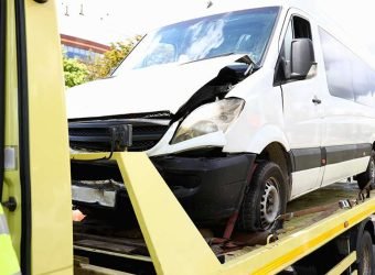 Wrecked car stands on tow truck closeup.