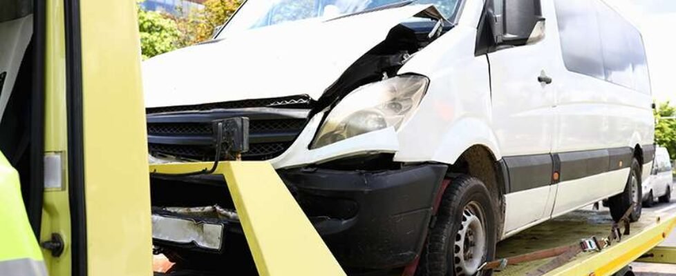 Wrecked car stands on tow truck closeup.