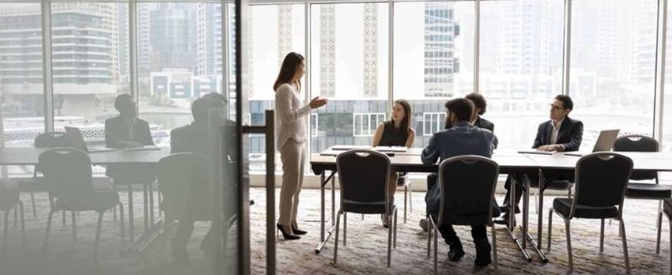 Wide,Shot,Of,Multiethnic,Business,Team,Talking,At,Meeting,Table