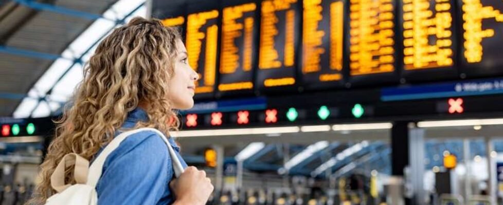 Traveler at the airport looking at the arrival departure board