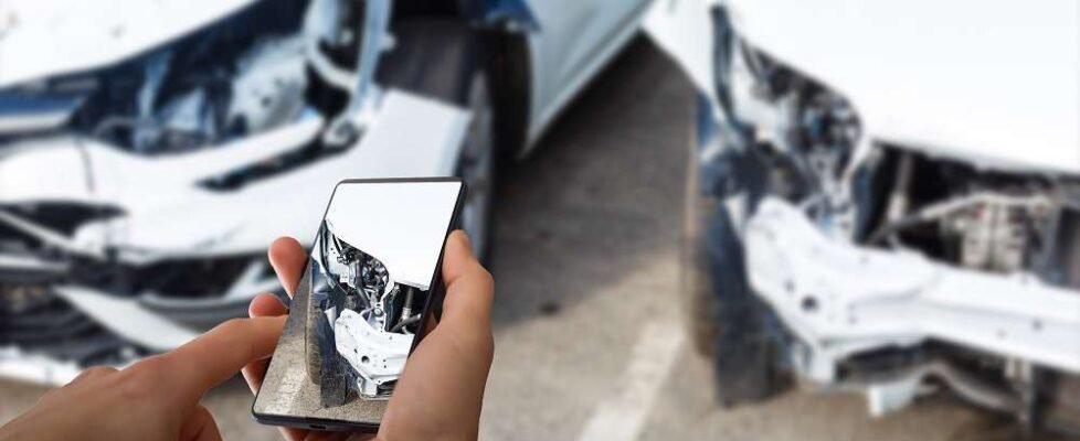 Man photographing his vehicle with damages for accident insurance with smart phone