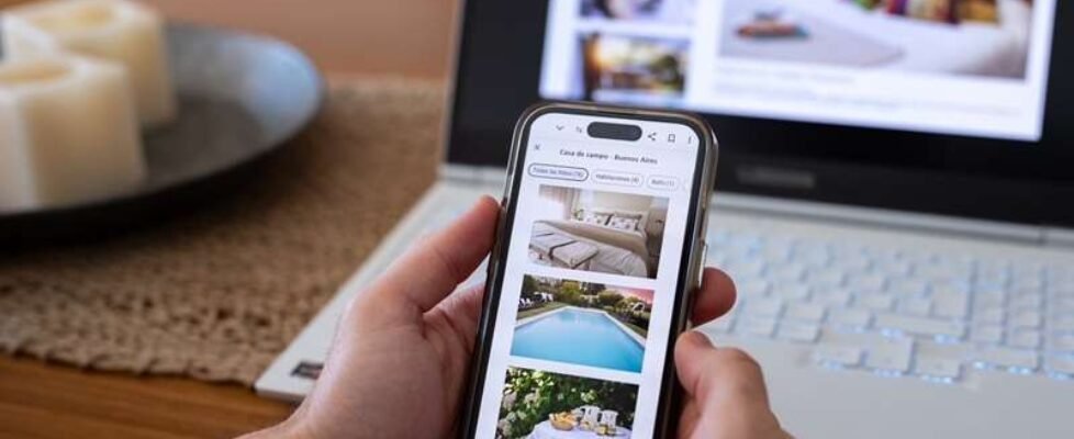 Unrecognizable person reviewing hotels online, using smartphone