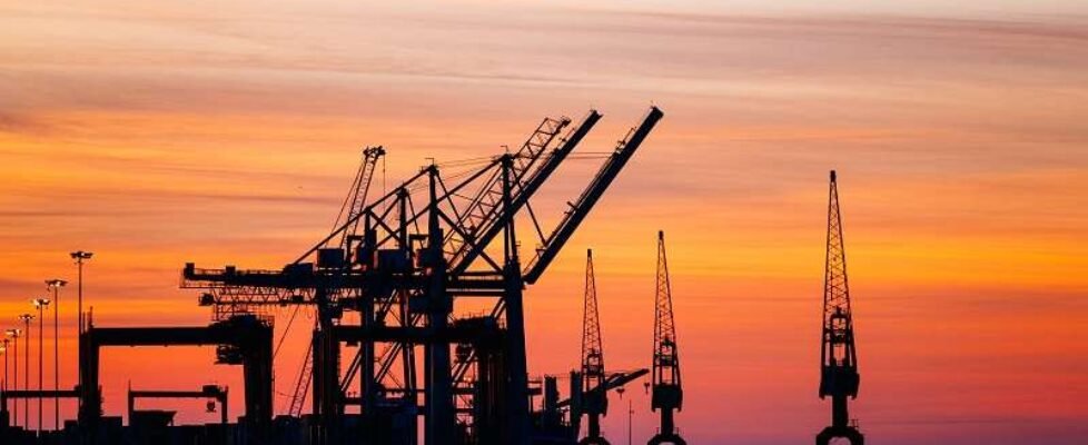 Beautiful silhouette of port machinery during sunset