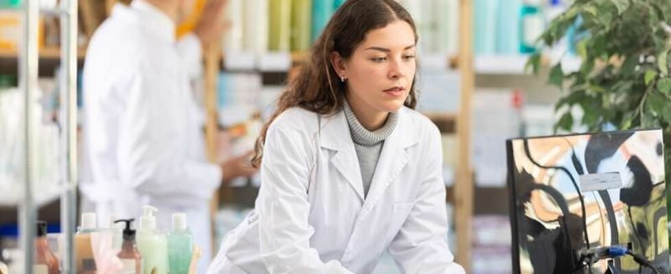 Young,Man,Pharmacist,Working,With,Computer,In,Pharmacy